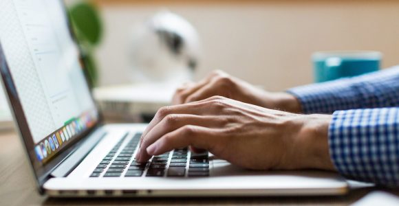 Person Typing on Keyboard